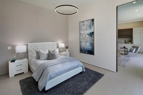 a bedroom with a bed and a lamp