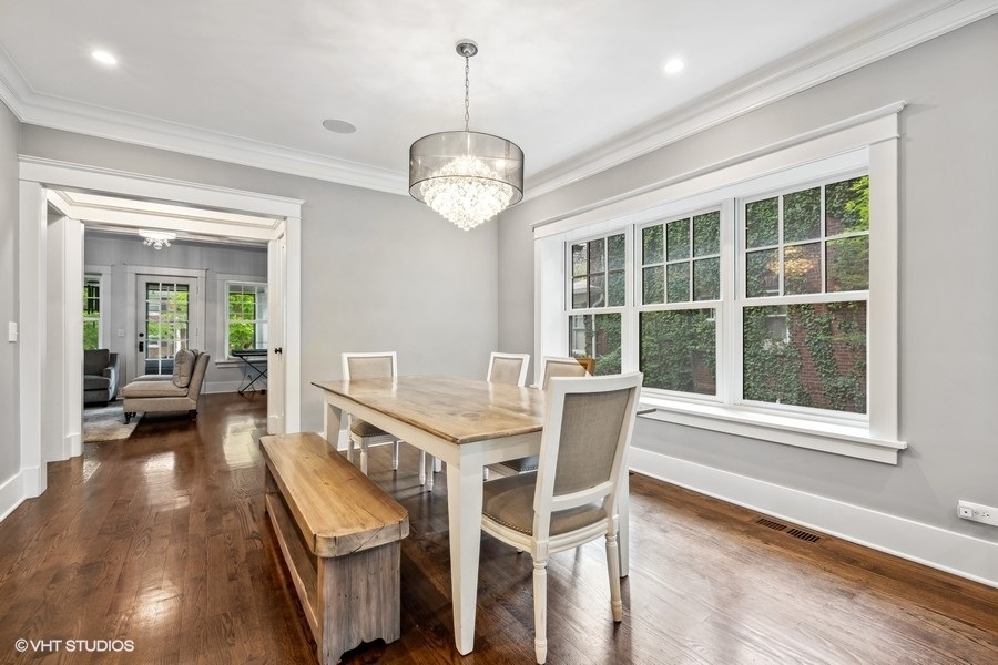 2236 Wesley Avenue Evanston, IL 60201 - Photo 11 of 25 a view of a dining room with furniture wooden floor and a chandelier