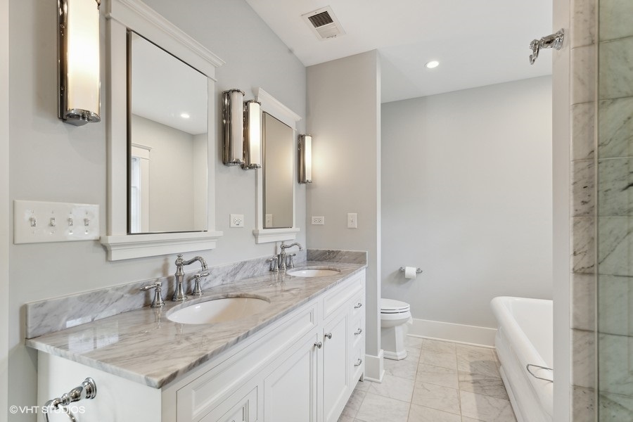 2236 Wesley Avenue Evanston, IL 60201 - Photo 19 of 25 a bathroom with a granite countertop sink and a mirror