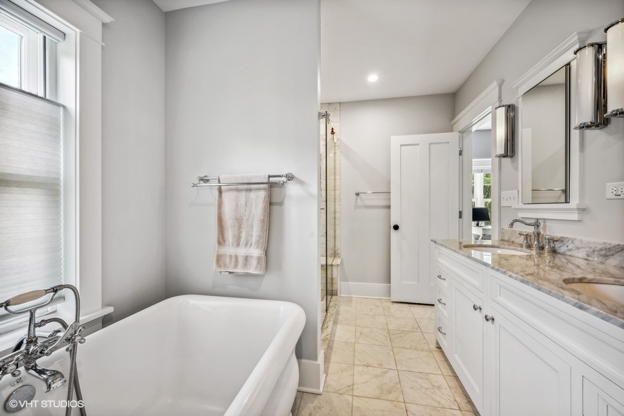 2236 Wesley Avenue Evanston, IL 60201 - Photo 20 of 25 a spacious bathroom with a double vanity sink a mirror and a bathtub