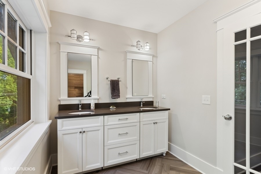 2236 Wesley Avenue Evanston, IL 60201 - Photo 22 of 25 a bathroom with double sink large mirror and a window