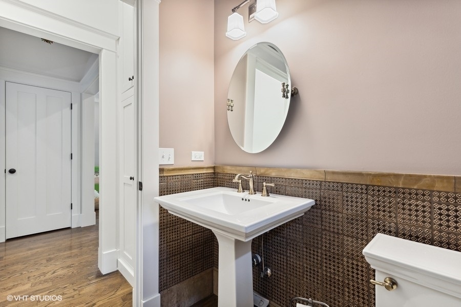 2236 Wesley Avenue Evanston, IL 60201 - Photo 7 of 25 a bathroom with a sink a toilet and a mirror