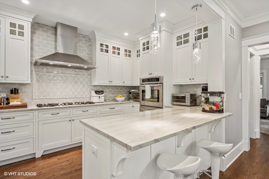 2236 Wesley Avenue Evanston, IL 60201 - Photo 8 of 25 a kitchen with stainless steel appliances a sink a stove a refrigerator and white cabinets