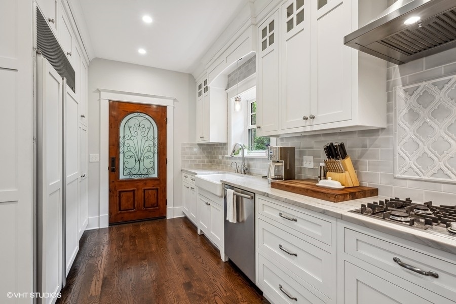 2236 Wesley Avenue Evanston, IL 60201 - Photo 9 of 25 a kitchen with stainless steel appliances a stove a sink and white cabinets
