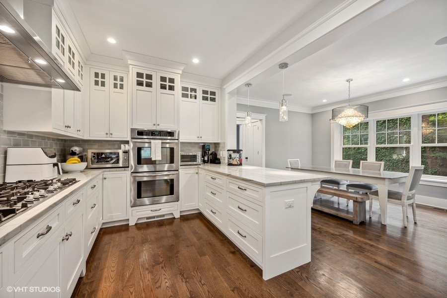 2236 Wesley Avenue Evanston, IL 60201 - Photo 10 of 25 a kitchen with stainless steel appliances granite countertop a stove oven and a refrigerator