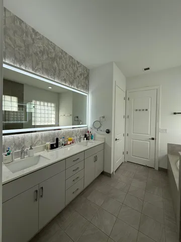 a white bath tub sitting in a bathroom next to a window