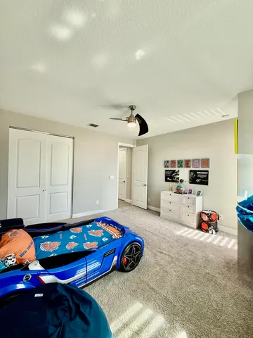 a bedroom with a bed and a chandelier