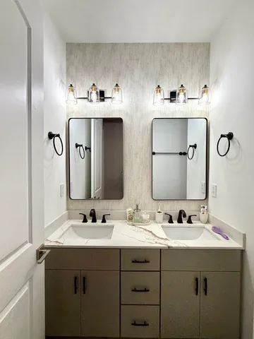 a bathroom with a sink toilet and mirror