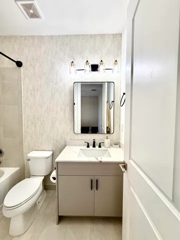 an empty room with a window and a ceiling fan