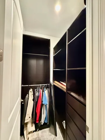 a view of a house with a tree in a garden