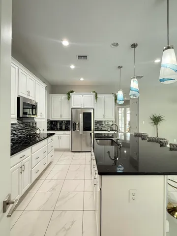 a dining room with furniture and a chandelier