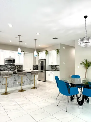 a kitchen with granite countertop a sink and a stove