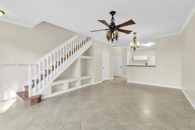 a view of a hallway with a ceiling fan