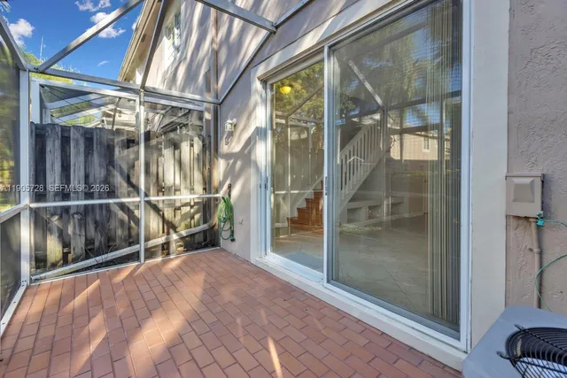 a view of a house with a large window and a yard