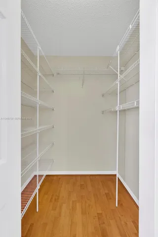 an empty room with a painting on the wall