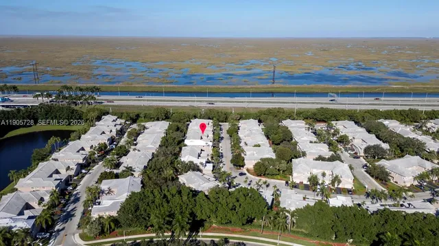 an aerial view of residential house with outdoor space and swimming pool