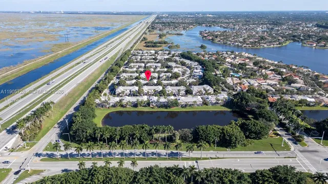an aerial view of a house with a yard and garden