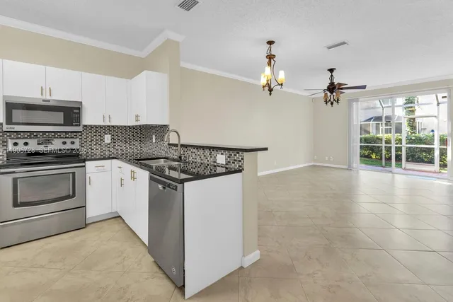 a kitchen with a refrigerator sink and stove top oven