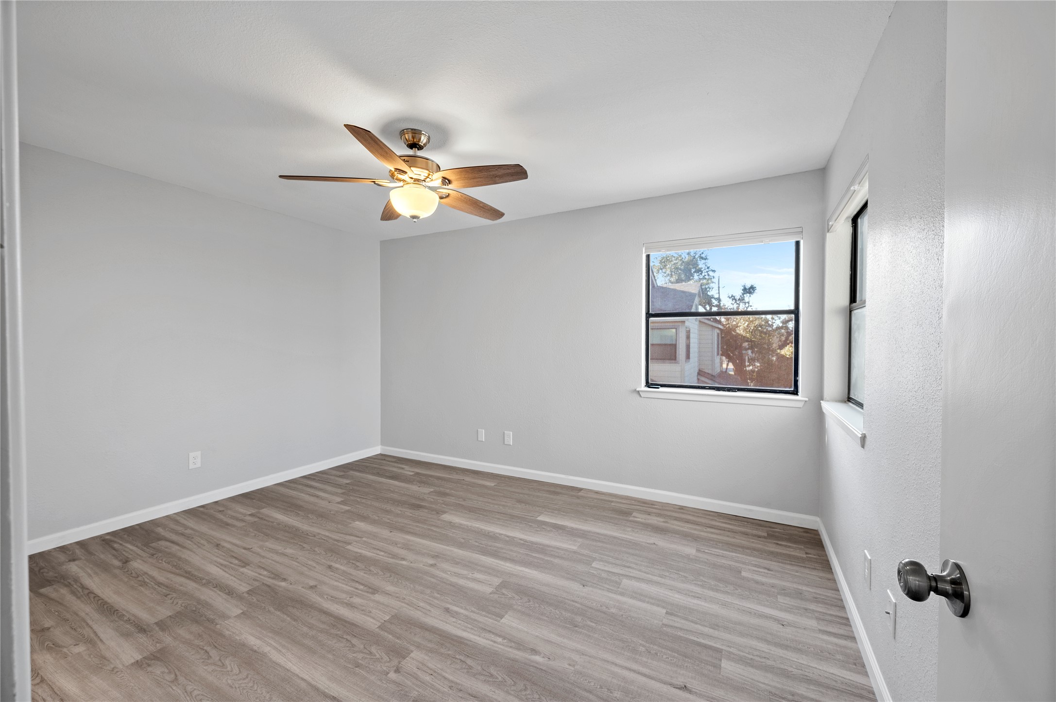 11301 Jollyville Road, Unit B3 Austin, TX 78759 - Photo 15 of 23 Empty room featuring light wood finished floors and a ceiling fan