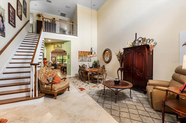 a dining room with furniture and a rug