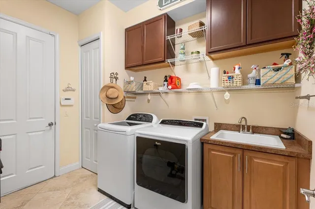 a living room with furniture a flat screen tv and a floor to ceiling window