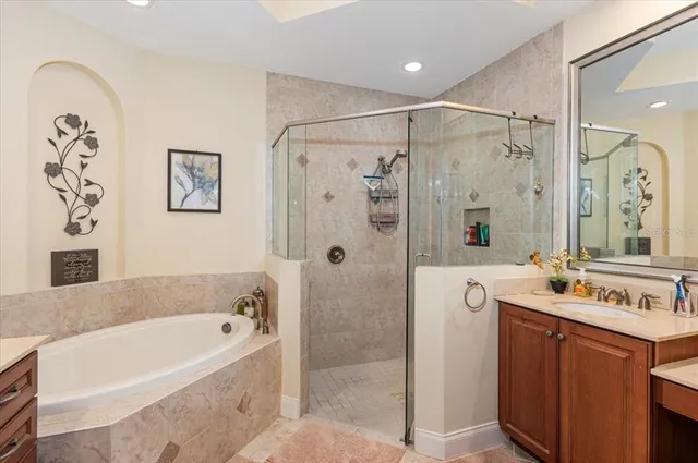 an aerial view of residential houses with outdoor space and trees