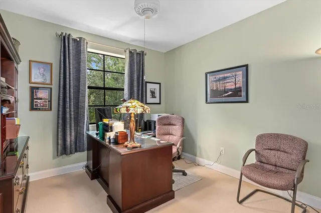 an aerial view of a house with swimming pool and garden