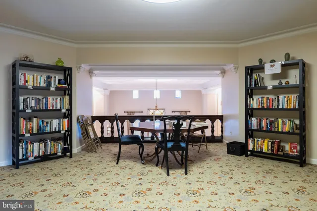 a view of a livingroom with furniture and bookshelf