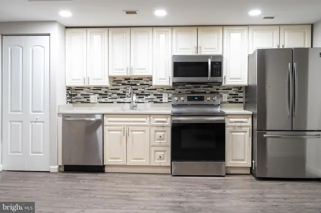 a kitchen with a stove and a refrigerator