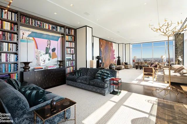 a living room with furniture and a book shelf