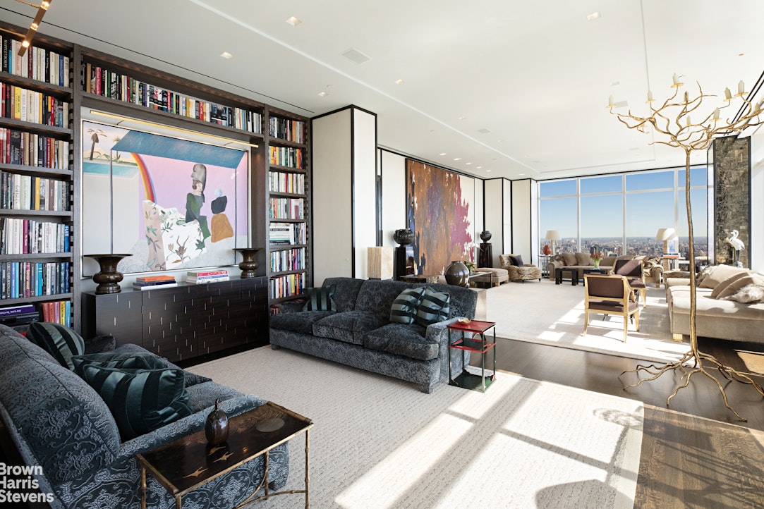 a living room with furniture and a book shelf