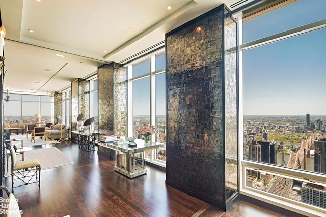 a very nice looking living room with a large window and wooden floor