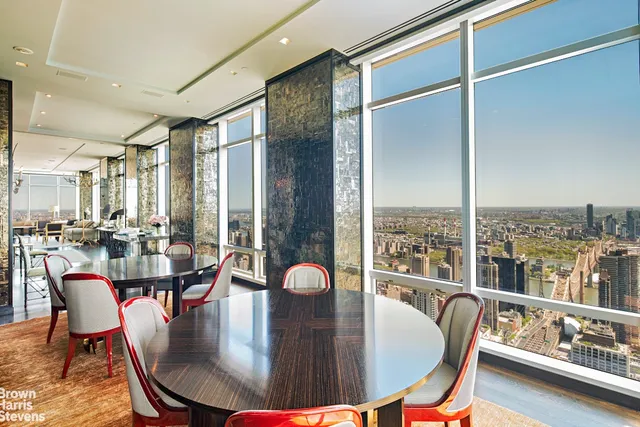 a dining room with furniture a chandelier and wooden floor