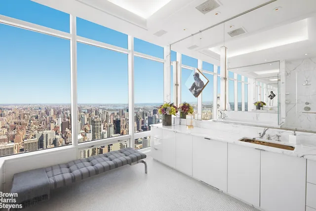 a bathroom with a granite countertop sink and a large mirror
