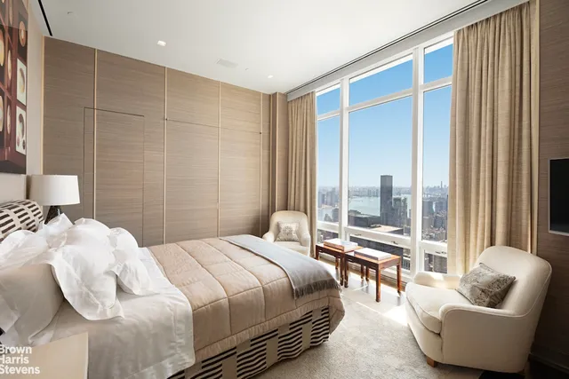 a bedroom with a bed and glass window