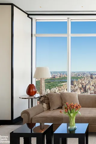 a living room with furniture and floor to ceiling window