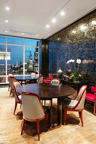 a view of a dining room with furniture and chandelier
