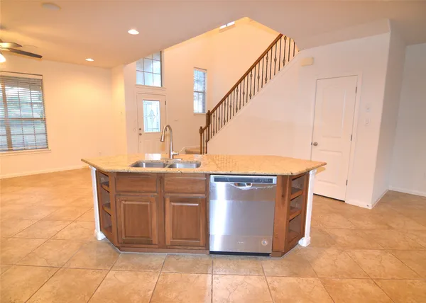 a kitchen with stainless steel appliances granite countertop a sink a stove and a refrigerator
