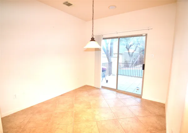 a view of kitchen with granite countertop window and sink