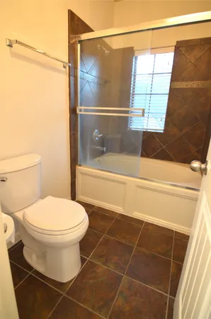 a en suite bathroom with a granite countertop sink and a mirror