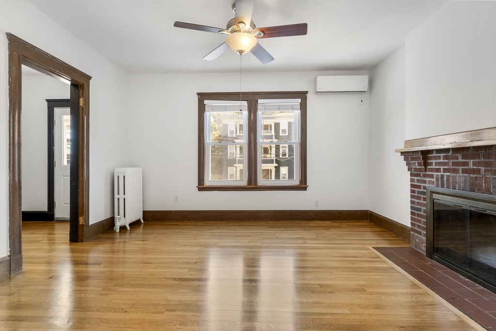 36 Turner Street, Unit 2 Boston, MA 02135 - Photo 19 of 31 wooden floor fireplace and windows in an empty room