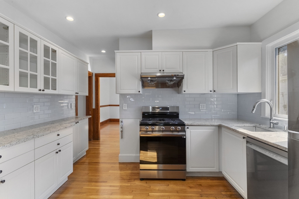 36 Turner Street, Unit 2 Boston, MA 02135 - Photo 2 of 31 a kitchen with kitchen island granite countertop a sink cabinets and stainless steel appliances