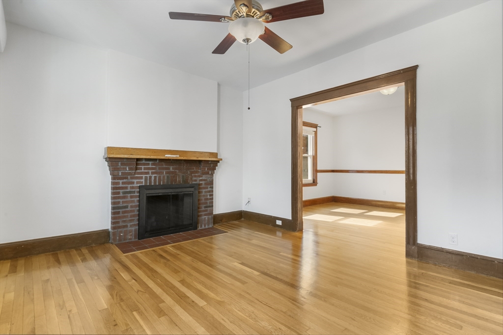 36 Turner Street, Unit 2 Boston, MA 02135 - Photo 22 of 31 a view of empty room with wooden floor and fireplace