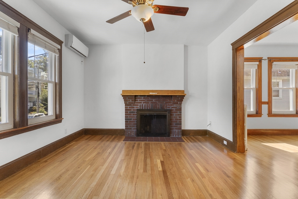36 Turner Street, Unit 2 Boston, MA 02135 - Photo 23 of 31 a view of an empty room with wooden floor fireplace and a window