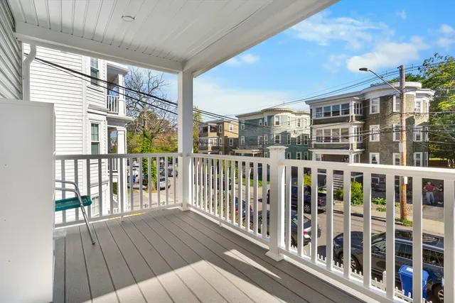 a view of a balcony with wooden floor