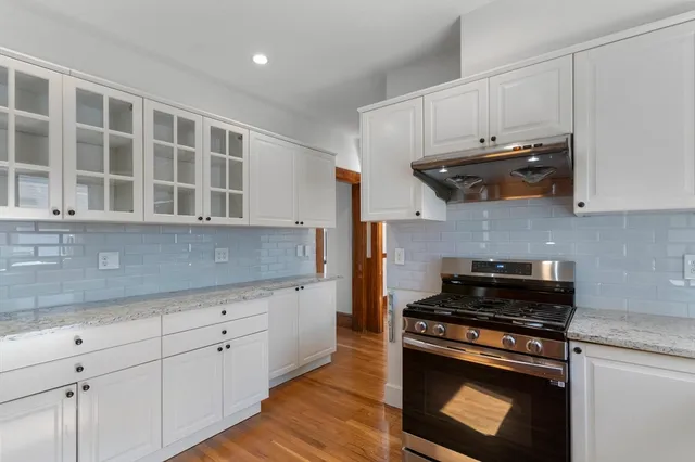 a kitchen with stainless steel appliances granite countertop a stove and a sink