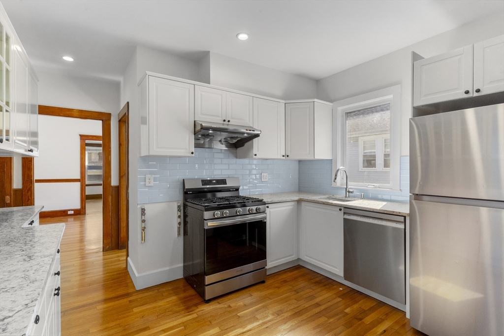 36 Turner Street, Unit 2 Boston, MA 02135 - Photo 4 of 31 a kitchen with stainless steel appliances granite countertop a stove a refrigerator and a refrigerator
