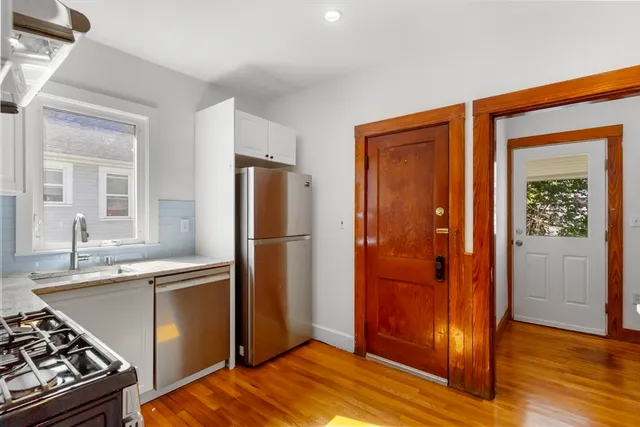 a kitchen with stainless steel appliances granite countertop a refrigerator and a sink