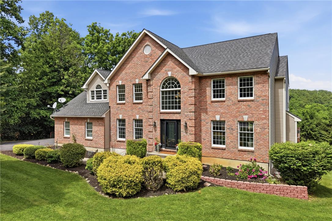 115 West Butternut Road Hellertown, PA 18055 - Photo 2 of 97 A classic brick exterior, framed by vibrant landscaping, welcomes you home.