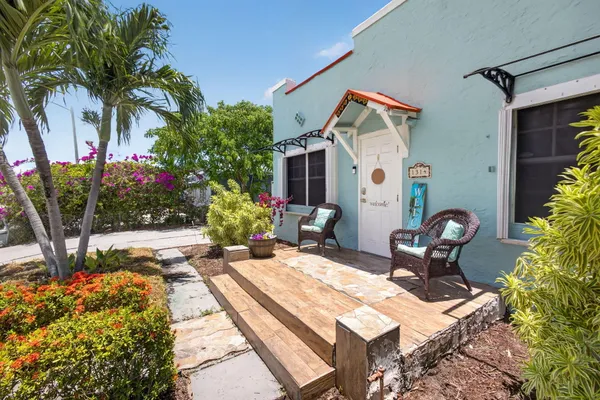 a backyard of a house with table and chairs